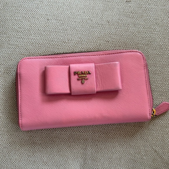 Prada Handbags - PRADA Zip around Peony Pink Saffiano Bow Wallet.